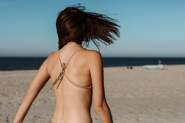 Back view of a woman in brown bikini for the best collagen supplements